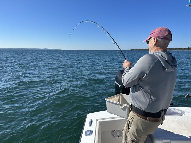 Angler fighting a fish on light tackle