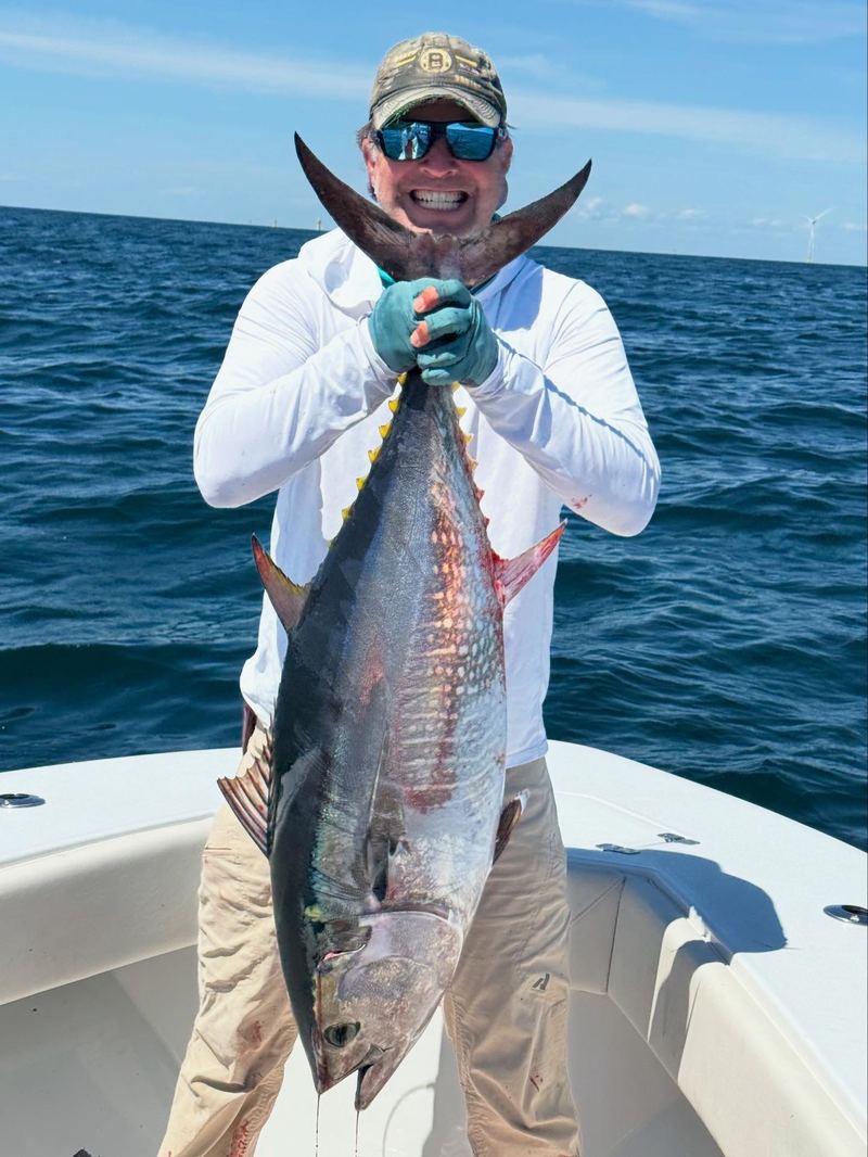 Angler holding a bluefin tuna caught jigging offshore of Cape Cod