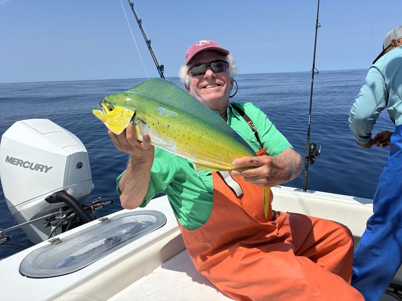 Angler holding a mahi mahi caught offshore of Cape Cod