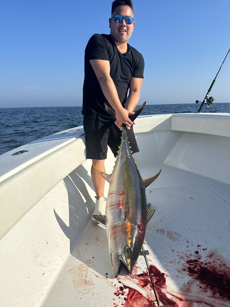 Angler with a bluefin tuna on the deck offshore of Cape Cod