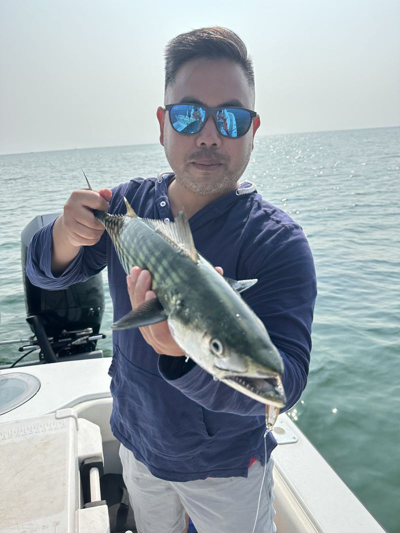 Angler with a false albacore on a light-tackle charter