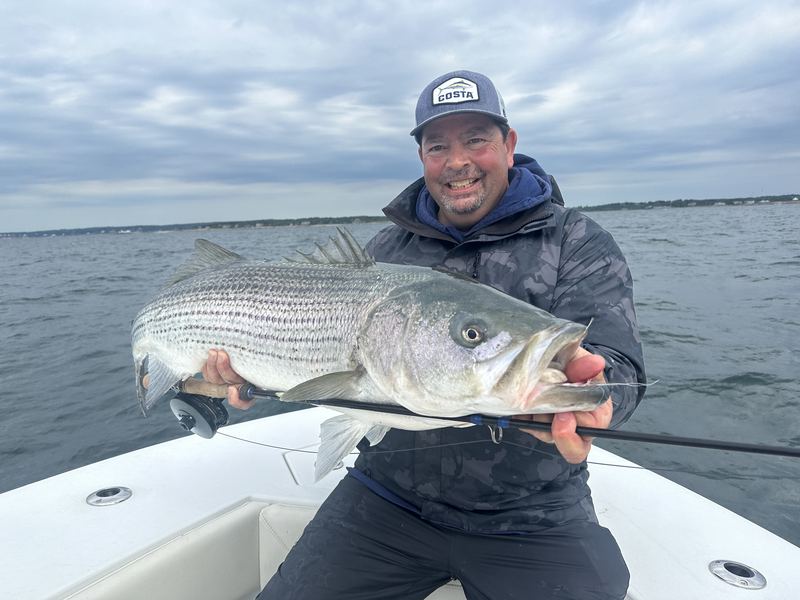 Angler with two big striped bass on the Conch 27