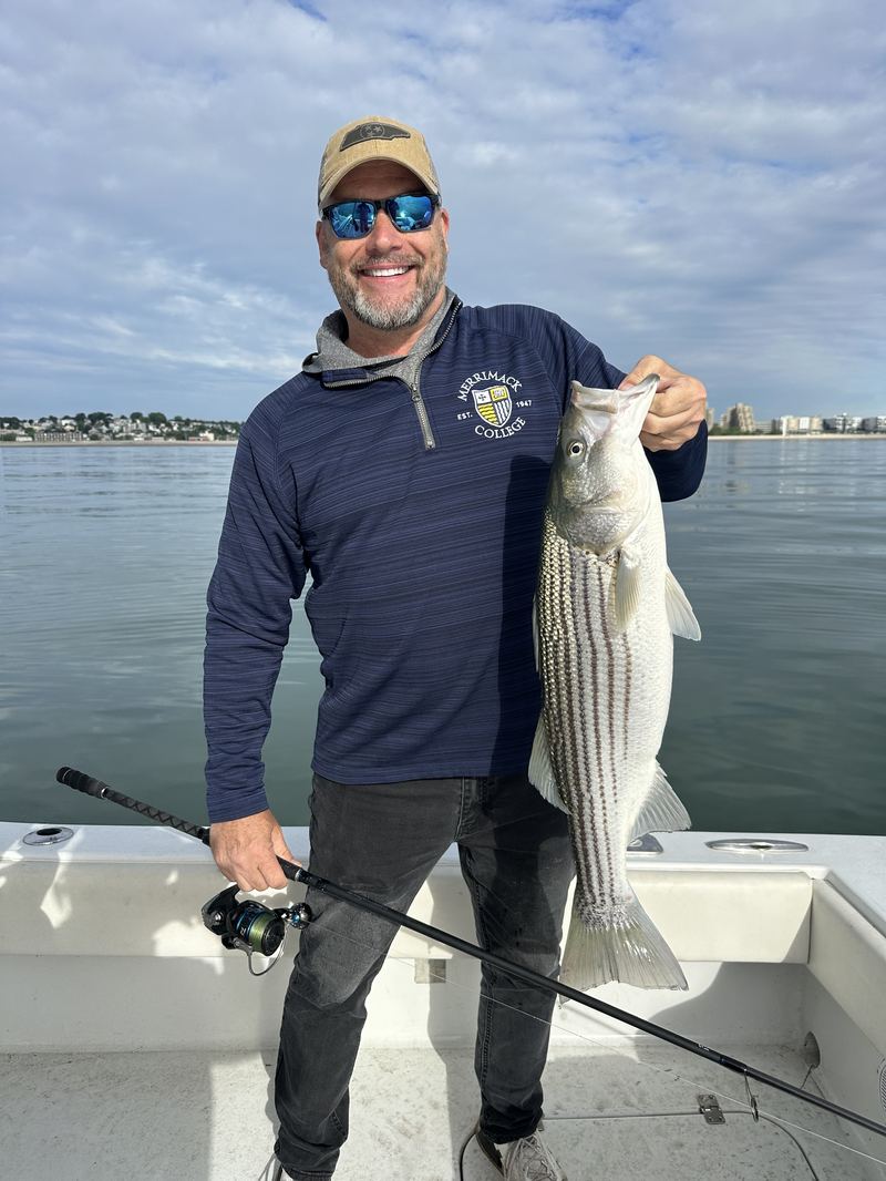 Striped bass caught with the Boston skyline in the background