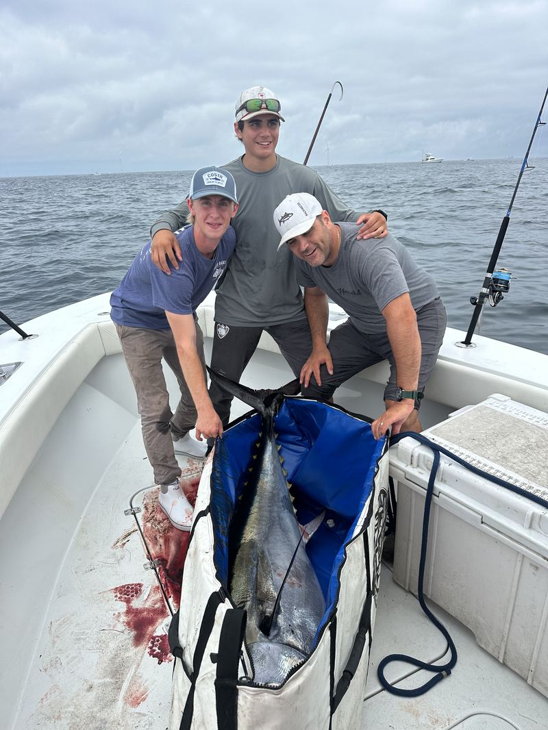 Two anglers with a bluefin tuna caught offshore